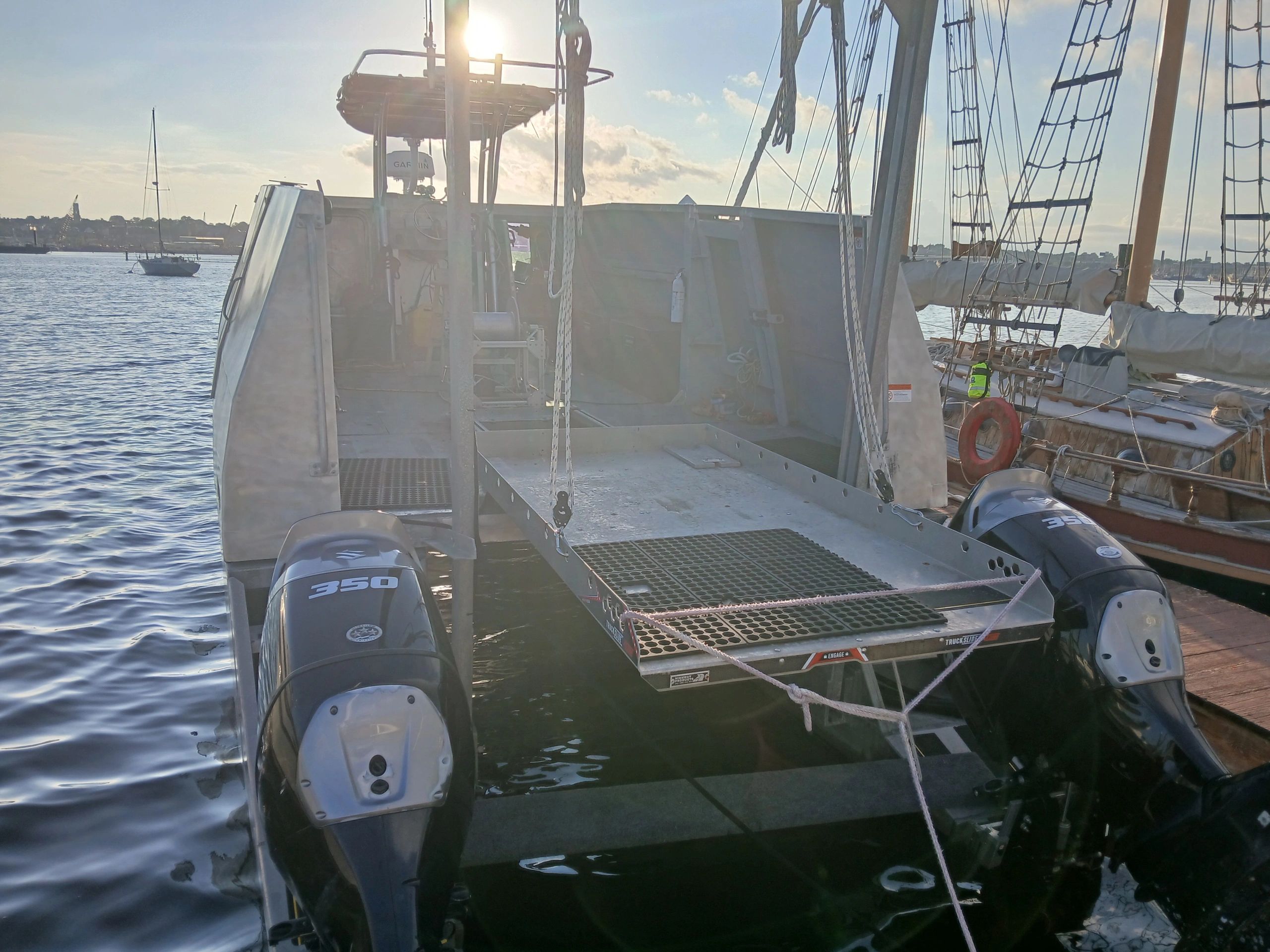 Boat equipped with two powerful 350 engines docked at the marina.