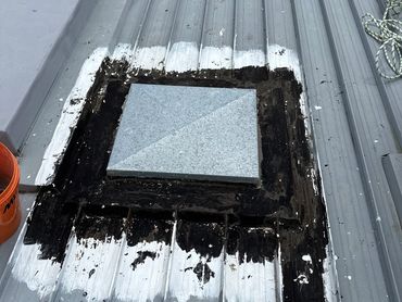 Metal roof with a sealed vent cover.