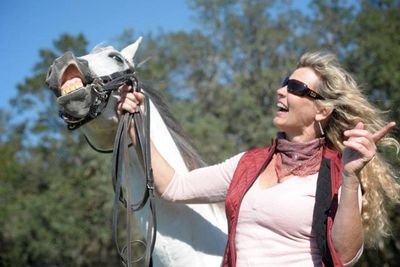 Heidi Herriott with a smiling horse