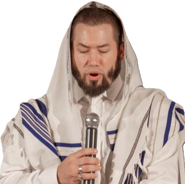 Cantor Will is is wearing a white tallit with blue and gold accents,  holding a microphone, and look