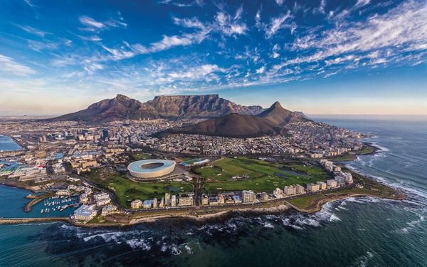 Aerial view of Cape Town with Table Mountain and the stadium by the coast.