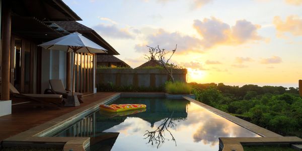A serene poolside at sunset with a float.