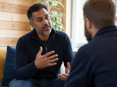 Two men having a serious conversation indoors.