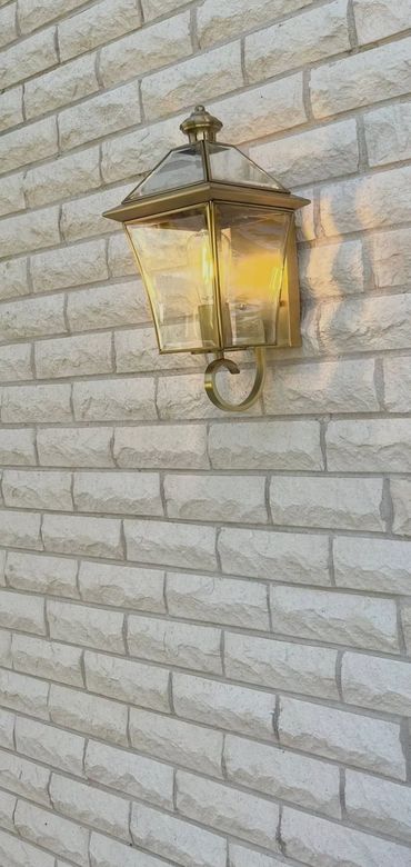 Outdoor wall light installation on brick home in Newcastle by licensed electrician