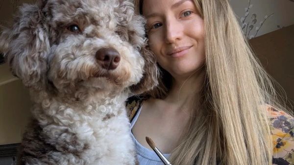 UK pet portrait artist Jo Shepherd, sat with her Miniature Poodle Jasper