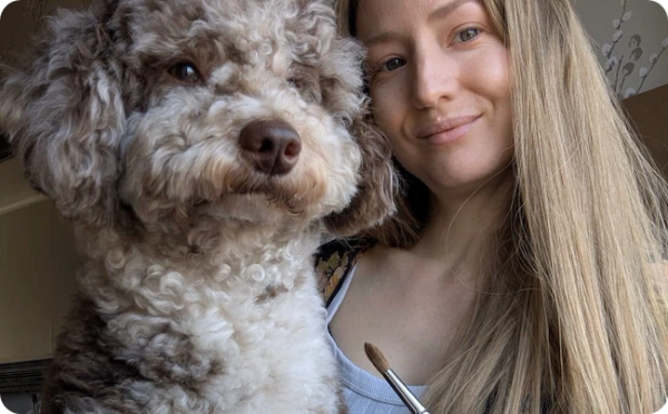 UK pet portrait artist Jo Shepherd, sat with her Miniature Poodle Jasper