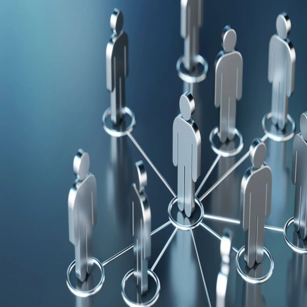 Metallic human figures connected in a network on a blue surface.