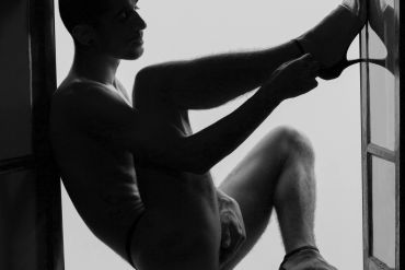 Homem em fotografia artística em preto e branco.