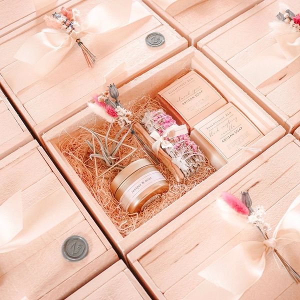 Wooden gift boxes with bows and hand-tied boutonniere. 