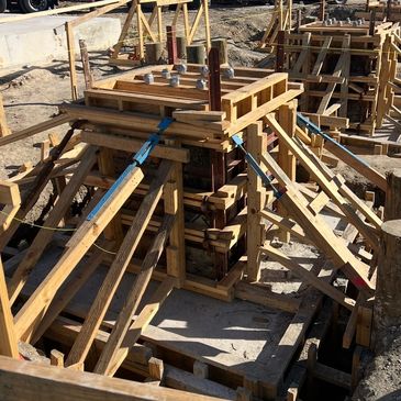 Wooden formwork and steel reinforcement set up for concrete foundation construction.