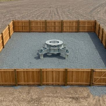 A fenced gravel area with a metal picnic table in the center.