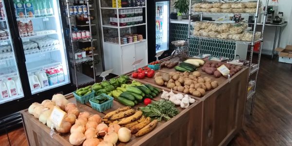 Indoor market display of fresh vegetables and fruits.