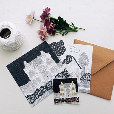 Black and white drawings with purple flowers and envelopes on a white surface.