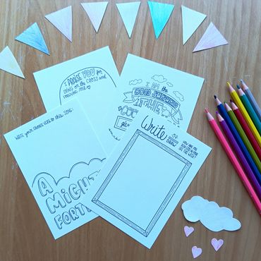 Creative coloring activity sheets with colored pencils and paper shapes.
