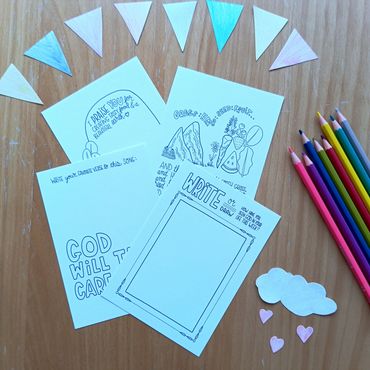 Coloring and drawing setup with doodle cards and colored pencils.