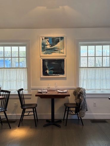 art on walls with table and chairs