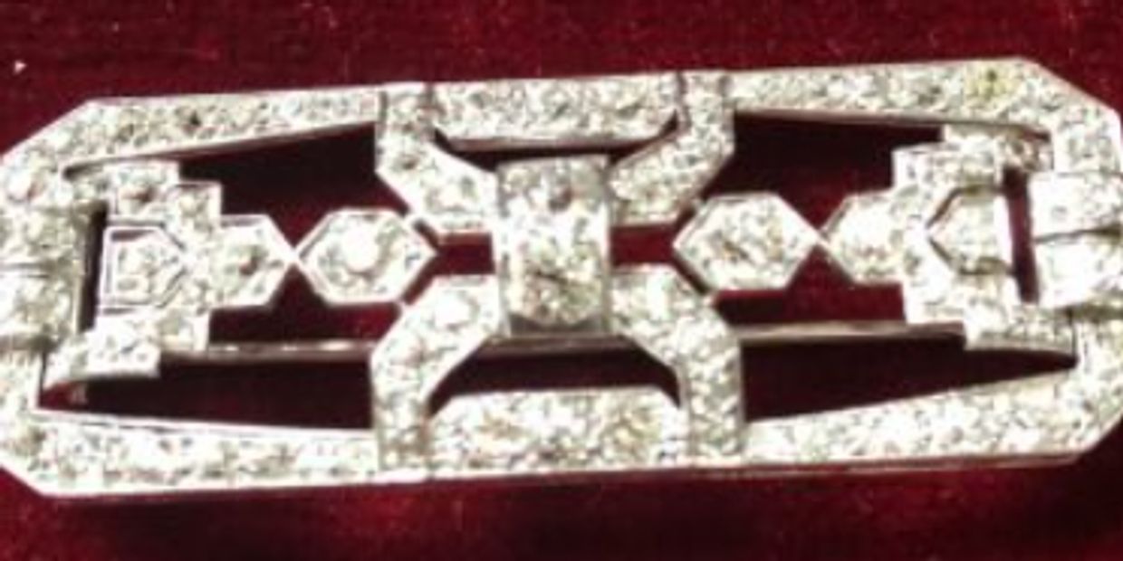 Vintage diamond brooch with geometric pattern.