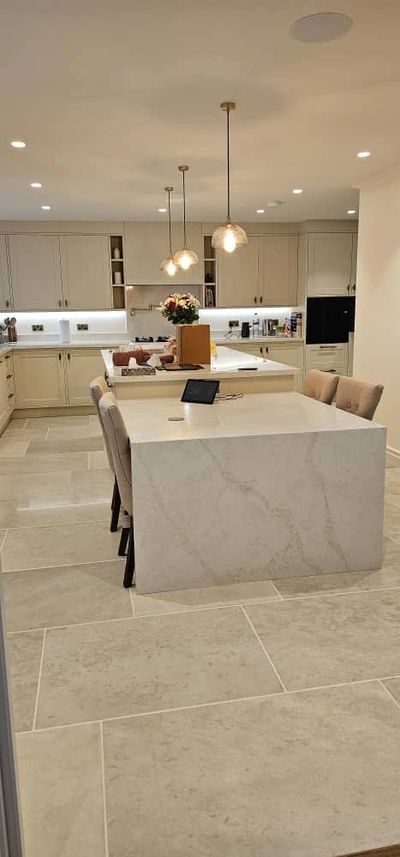 Modern kitchen with a marble island and pendant lighting. after-build cleaning, end-of-tenancy cleaning, regular domestic cleaning 