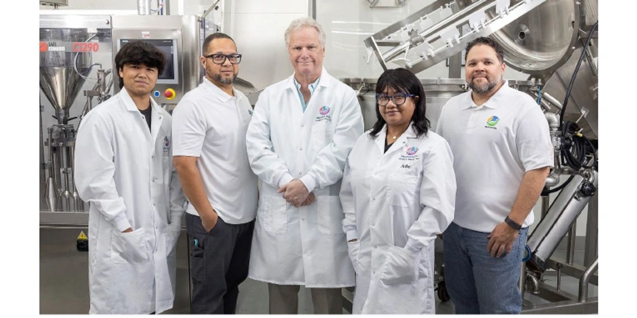 Group of scientists in white lab coats in a laboratory.