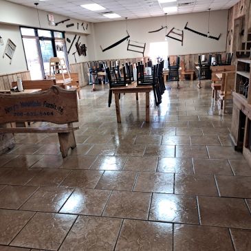 Empty workshop with wooden furniture and tools mounted on the walls.