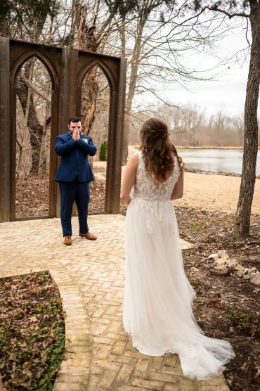 Groom reacts emotionally seeing bride in wedding dress for the first time.