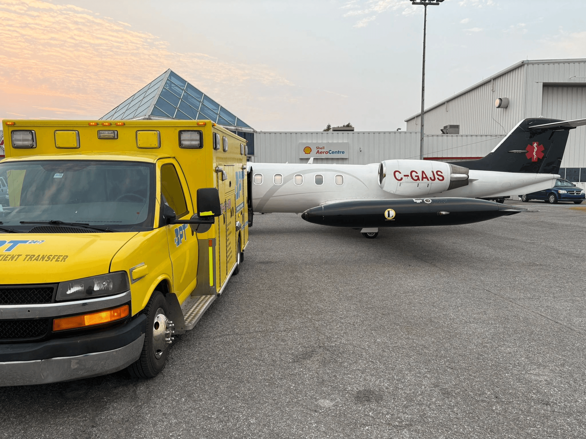 BPT-24-7 stretcher van next to Latitude Air Ambulance aircraft