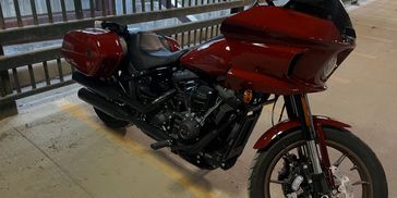 Red Harley-Davidson motorcycle parked in a covered area.