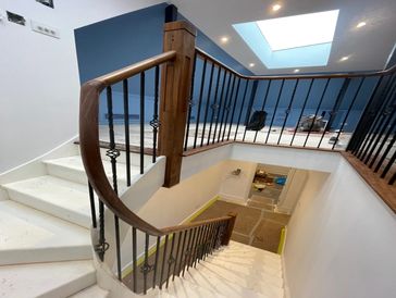 Bespoke wooden staircase with iron rods