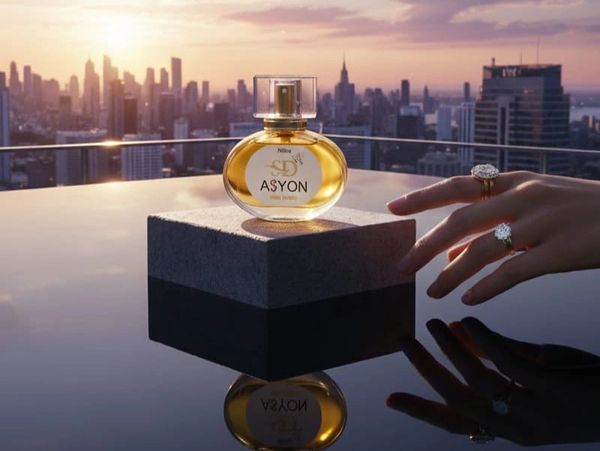 Perfume bottle on a pedestal with city skyline and sunset background.