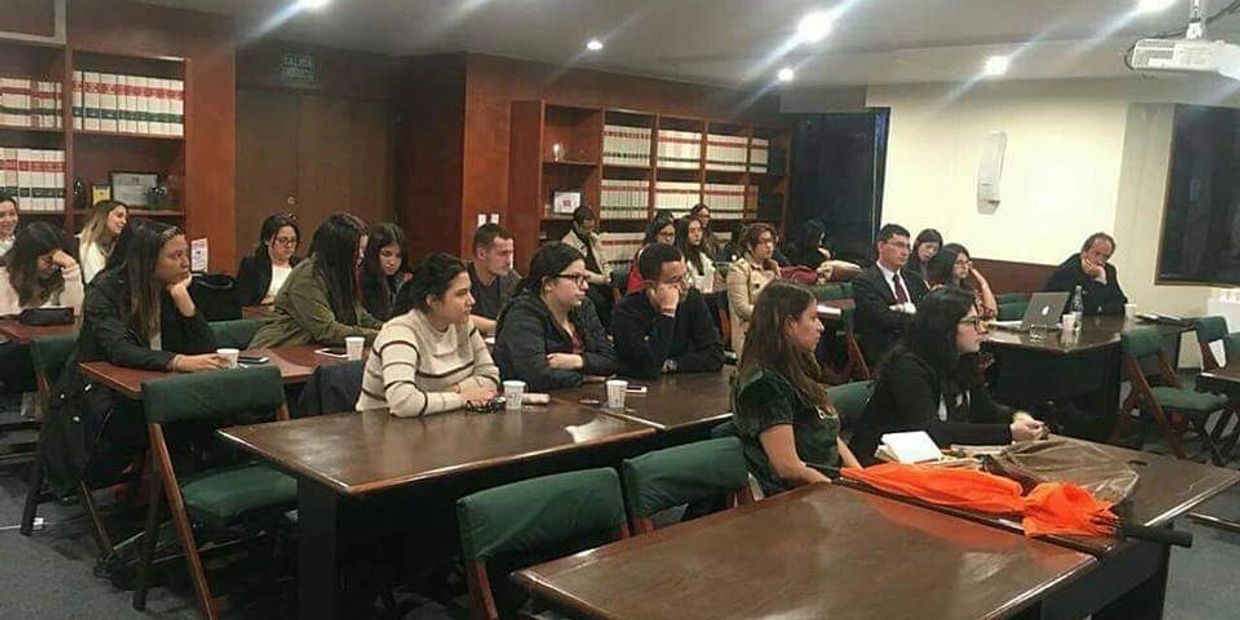 People attentively listening in a classroom or seminar setting.