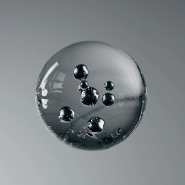 A transparent bubble with smaller bubbles inside floating against a gray background.