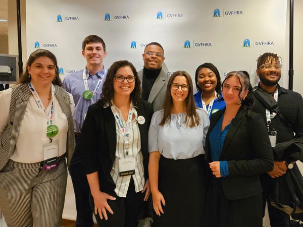 A diverse group of seven smiling professionals posing at a GVFHRA event.