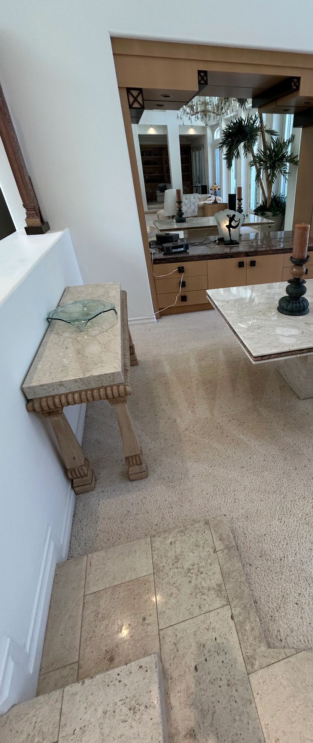Indoor marble and wood furniture near carpet and tiled floor.