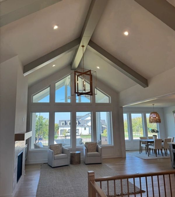 Bright living room with vaulted ceilings and large windows.