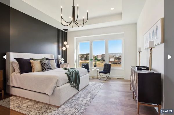 Modern bedroom with a large bed and stylish decor.