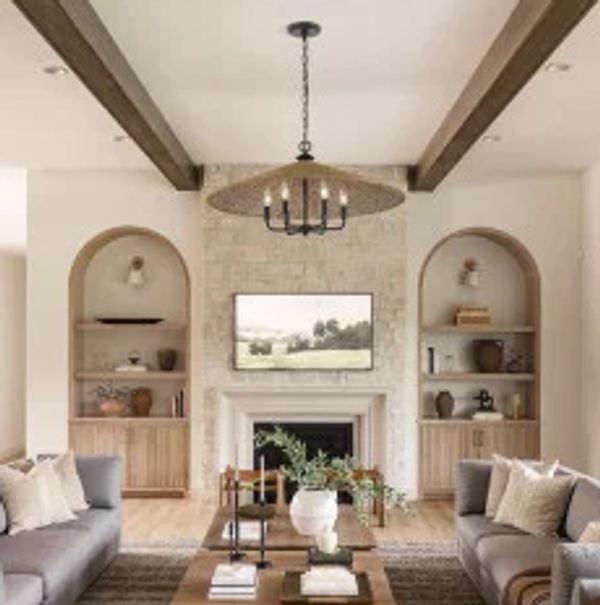 Cozy living room with stone fireplace and wooden beams.