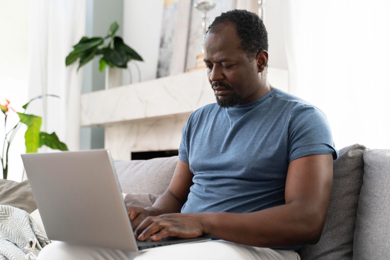 middle aged black man  laptop sofa couch session online men mental health 