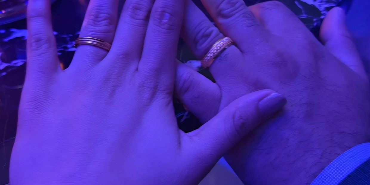 Michael Thomas and Praisey Yesudas showing their wedding rings from March 27, 2025.