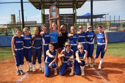 Girls softball team posing on field.