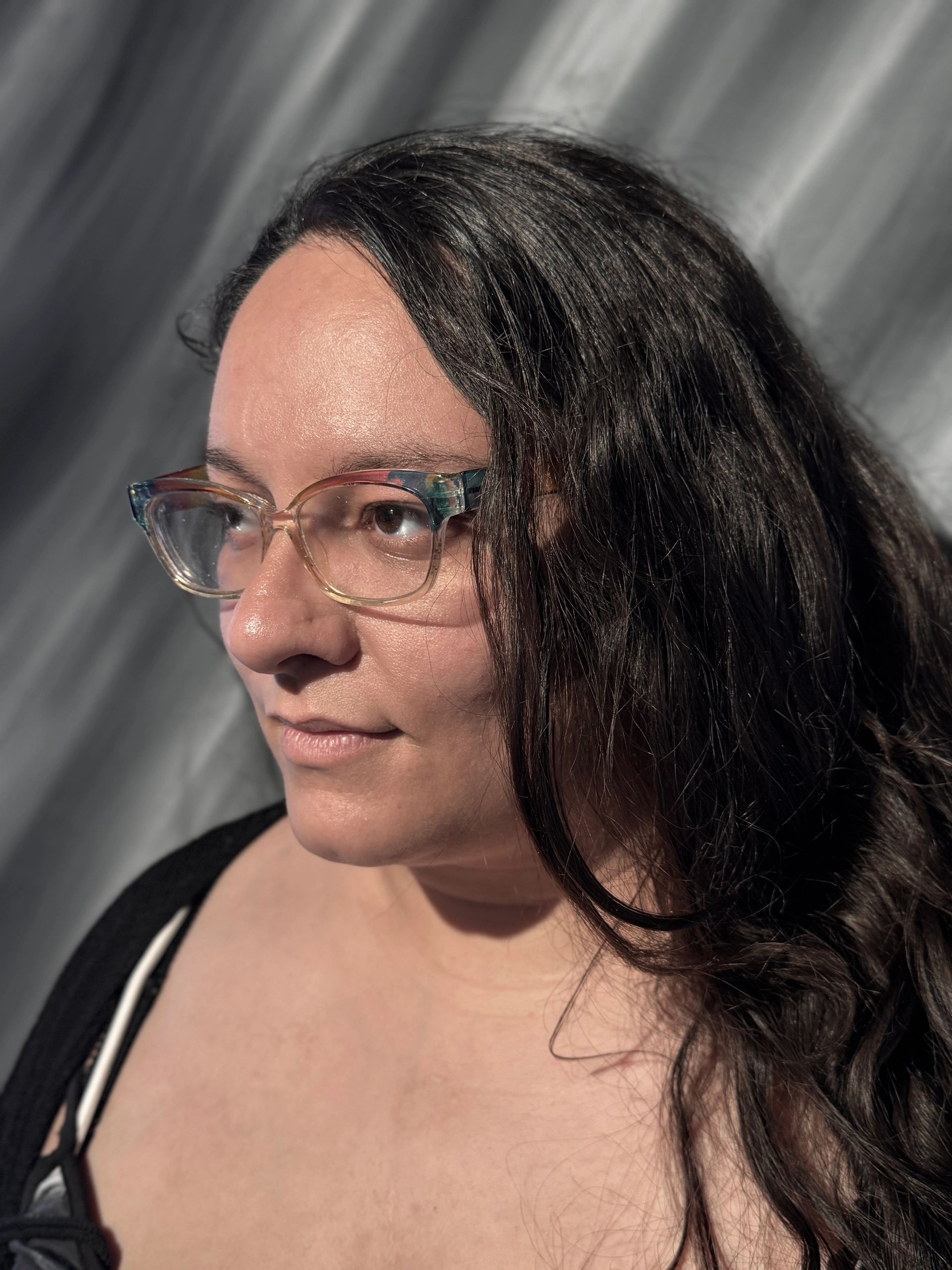 Black and white close-up portrait of a woman with glasses.