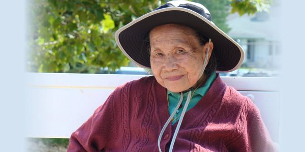 A old woman sit on the Chair and looking ahead