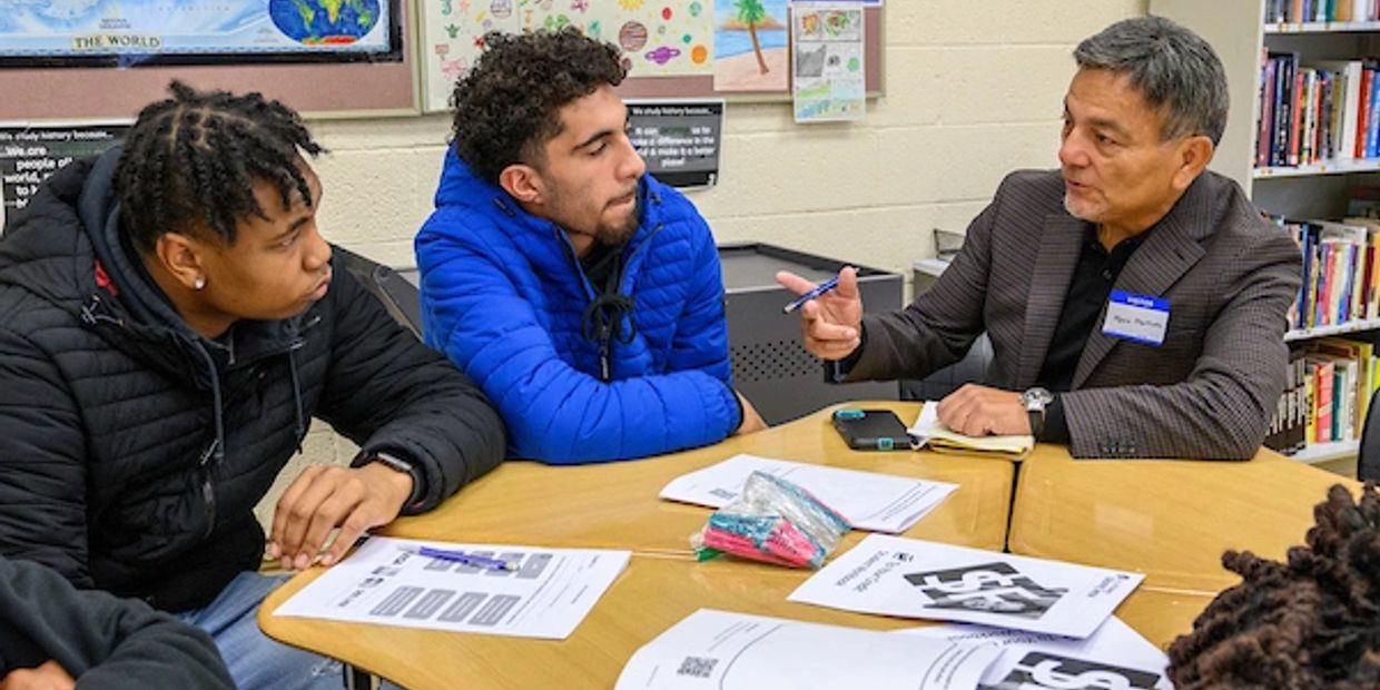 Mentor advising students in classroom.