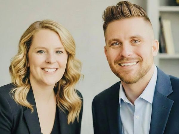 Smiling professional man and woman in business attire for real estate and insurance.