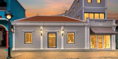Charming Littman's store with warm lights at dusk.
