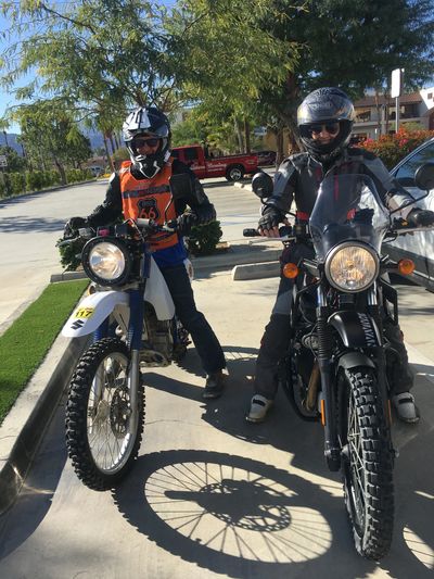 Two motorcyclists ready to ride on sunny day.