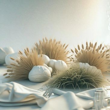 Elegant table centerpiece with dried floral arrangements and white pumpkins.