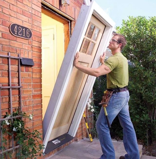 Man installing a full door system including the door frame.