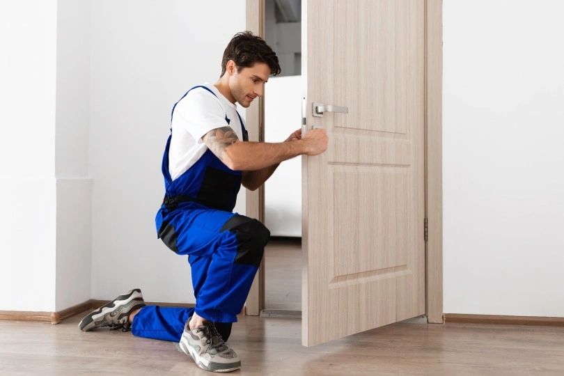 Door repair being conducted by a door repairman
