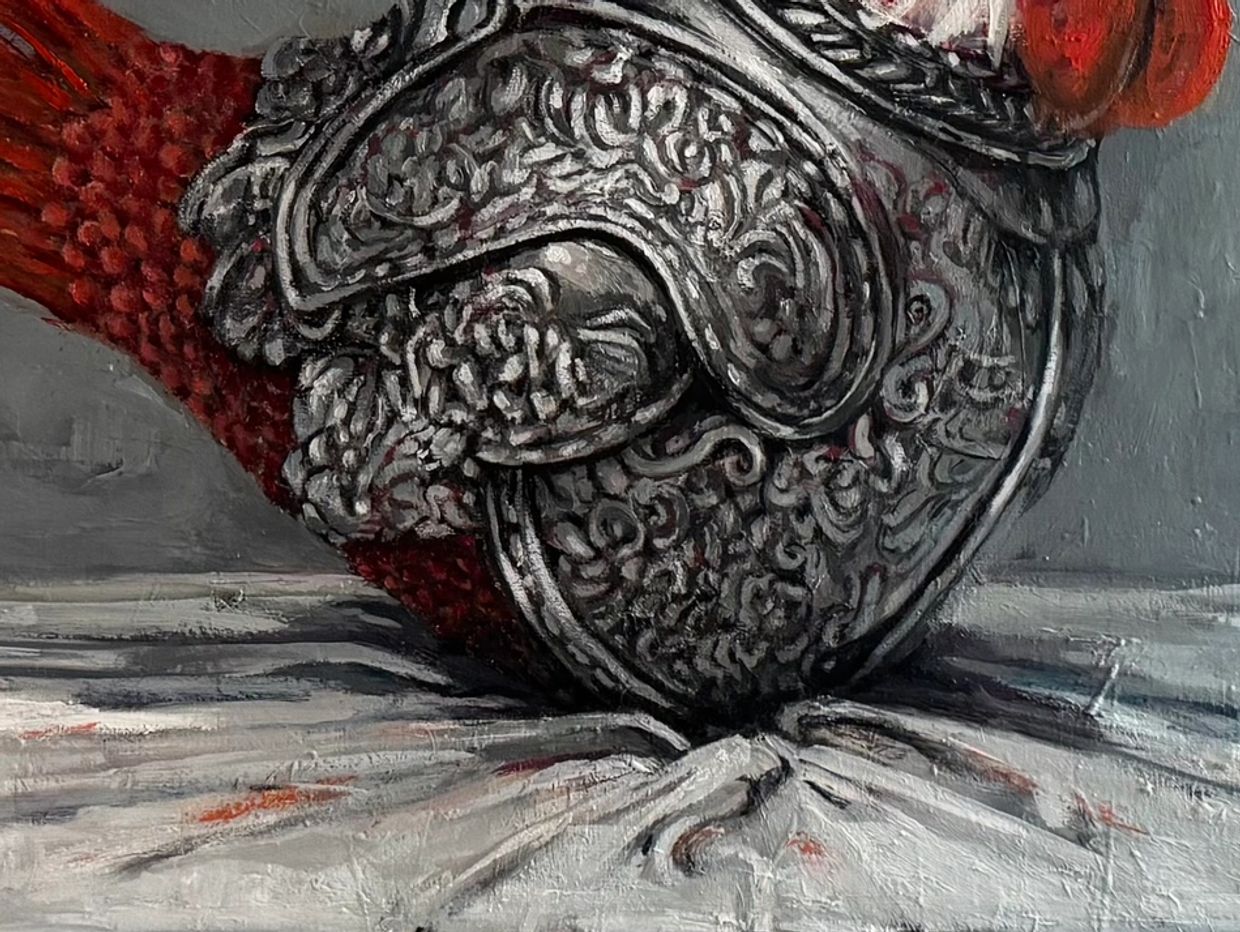 Intricately detailed metallic glove on a textured surface.