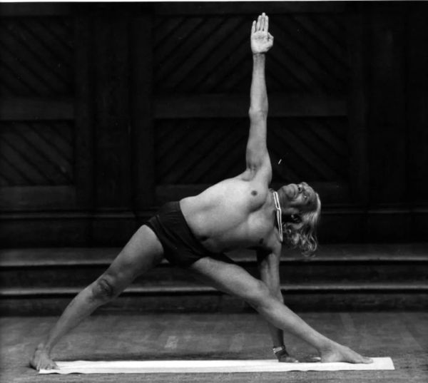 Man performing a yoga pose indoors.